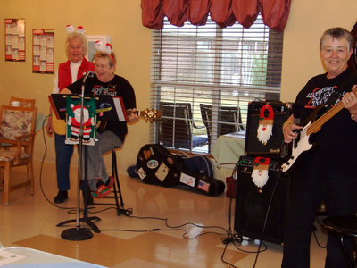 Image: Singing up a storm — Vivian Brooks and Sue and Bobbie Brooks singing Merry Christmas.