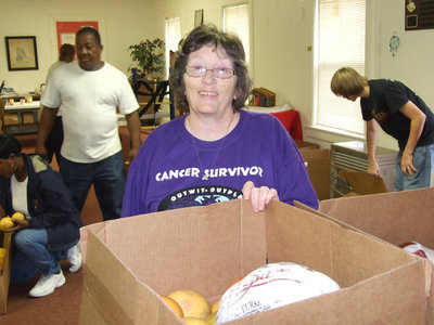Image: Karen delivers with a smile — Karen and Brian Mathiowetz helped organize the food deliveries.