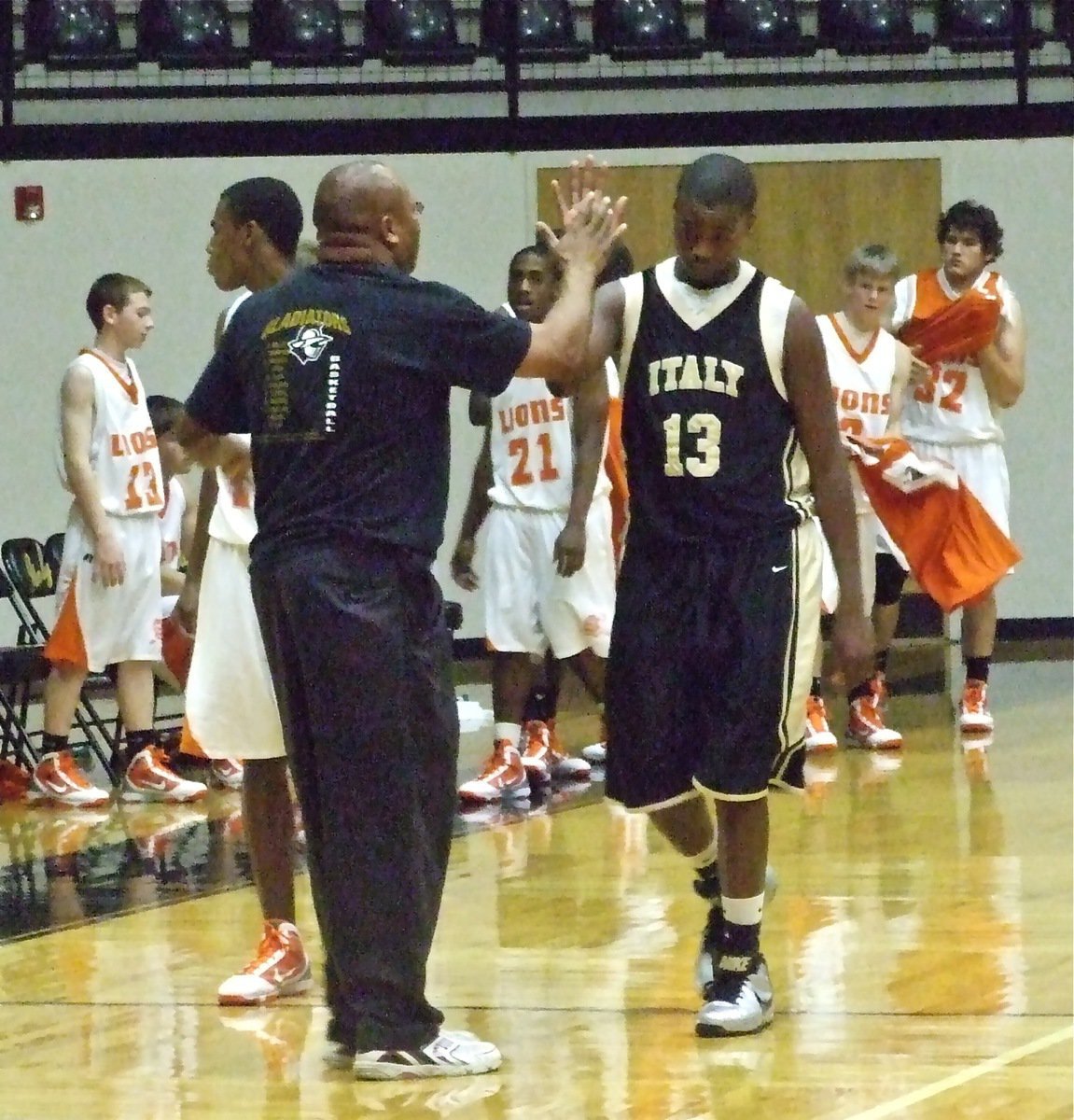 Image: Dad and son… — …Coach and player. Italy JV Head Coach Larry Mayberry congratulates his son for a nice effort that helped the Italy JV Gladiators upset the Teague varsity squad on Day 2 of the Italy Invitational Tournament.