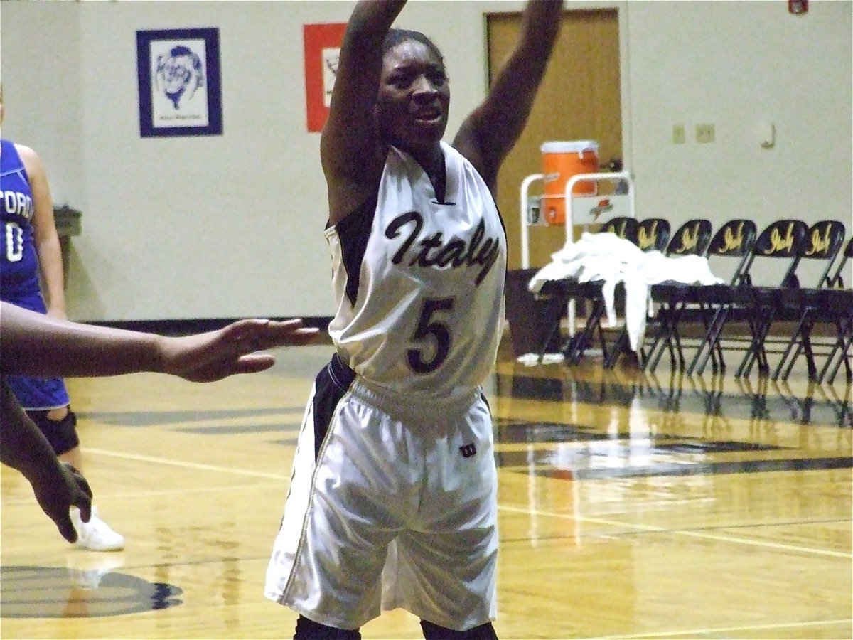 Image: Copeland tickled — It appears Italy Lady Gladiator Jameka Copeland(5) avoids being tickled while shooting her free throw.