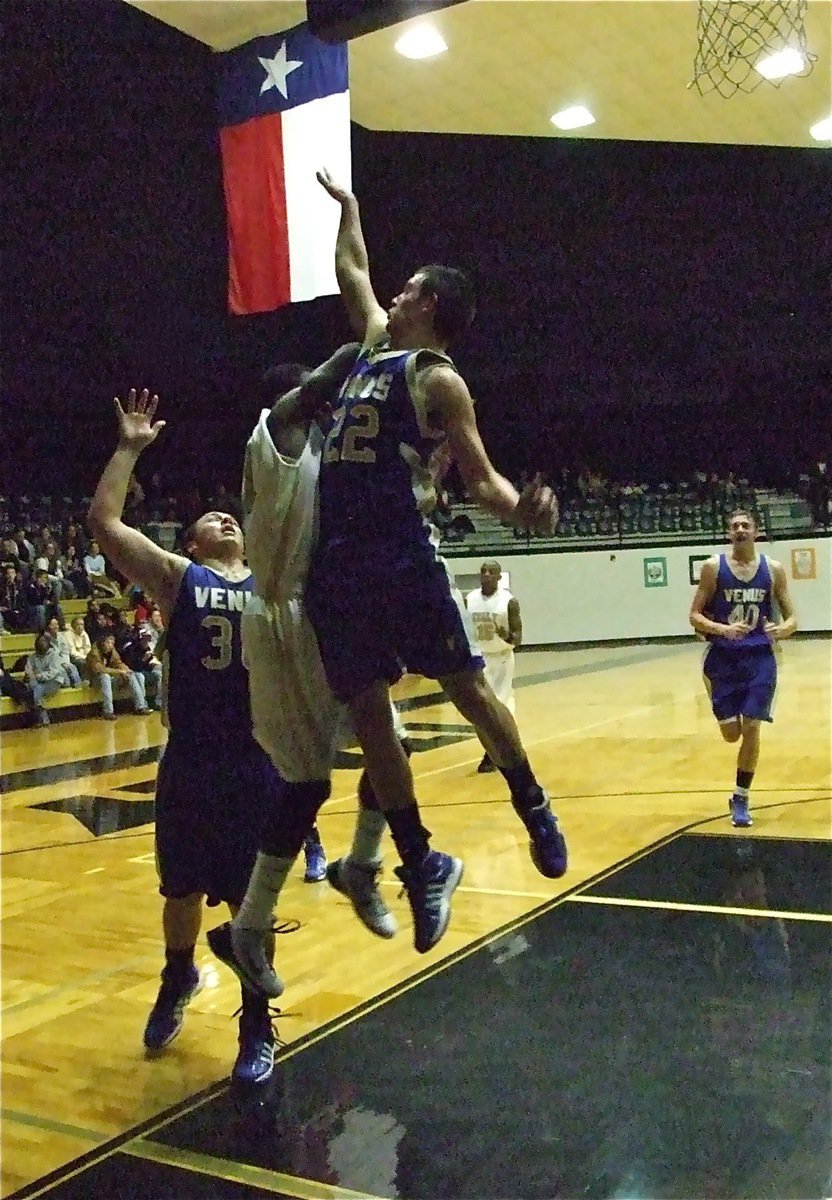 Image: Sandwiched — Italy’s Jasenio Anderson(11) draws a foul against Venus on his way to the hoop.