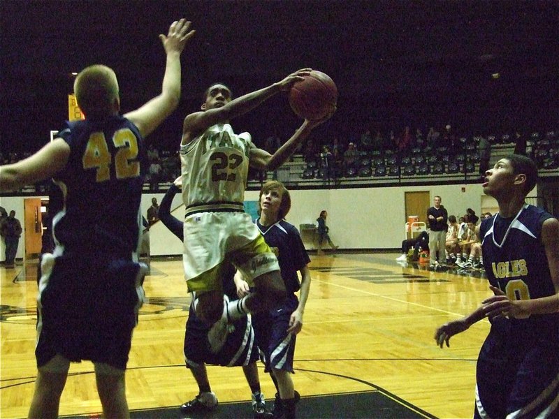 Image: Heath creates — Heath Clemons(22) drives right thru the middle of the Eagle defense.