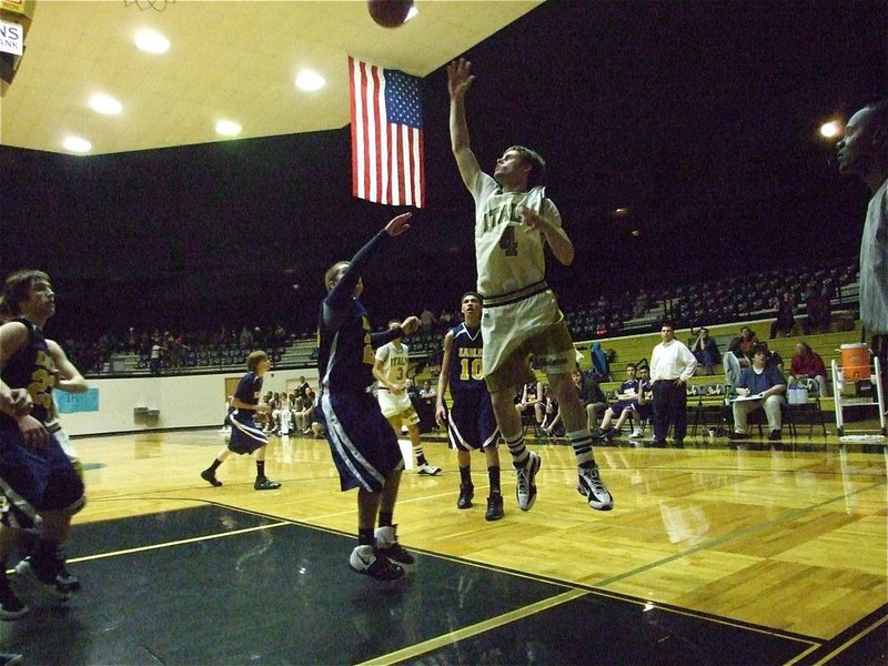 Image: Ashcraft dazzles — These old uniforms look good as new as current Gladiator Ryan Ashcraft(4) scores inside.