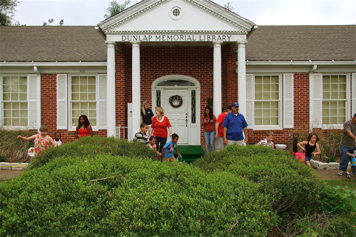 Image: Dunlap Memorial Library hosts annual Easter Egg hunt — Dunlap Memorial Library’s, Kathy French, announces the beginning of the Easter Egg hunt as excited youngsters begin the search.