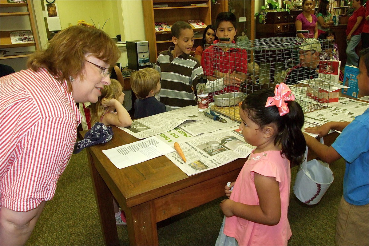 Image: Easter is educational — Why do bunnies have pink eyes? Anne Sutherland answers questions regarding her bunny, Sparkle, before the Easter Egg hunt.