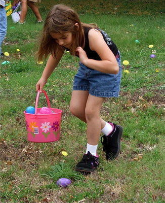 Image: Evie’s on the hunt — Evie Hernandez has her eye on a purple egg.