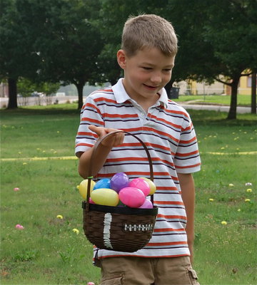 Image: Hunting skills — Taylor Sparks balances his overflowing easter basket with just one finger.