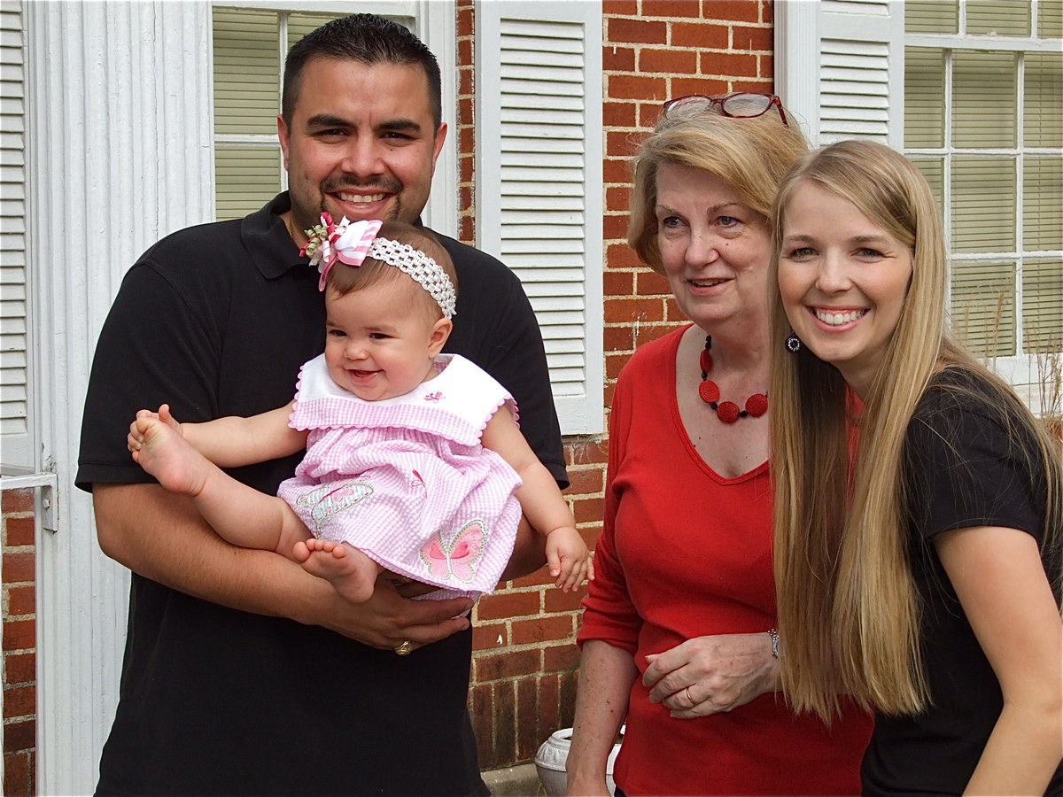 Image: A family event — Kathy French poses for Easter pictures with Diego Garcia, his daughter, Avery, and his wife, Jody, after the 28th Annual Easter Egg hunt held at the Dunlap Memorial Library.