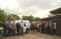Image: Group attending poses in front of new van.