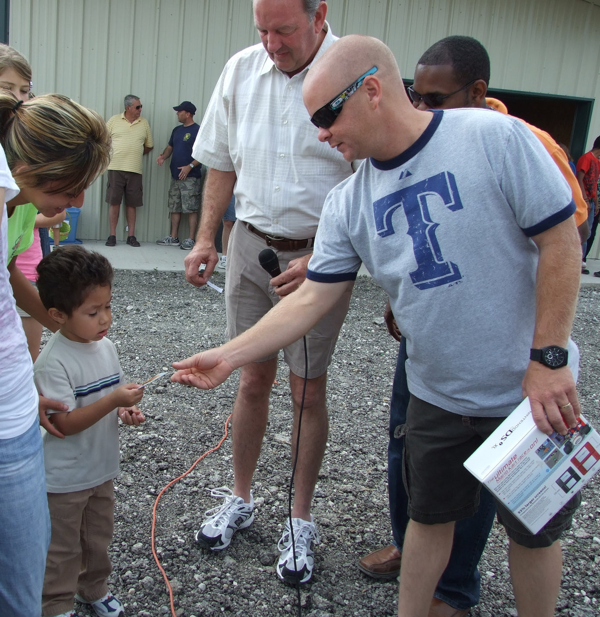 Image: What is this? — Michael Chambers helps hand out prizes.