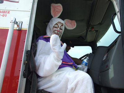 Image: I have to hop now — Before the Fire Department whisked him away, the Easter Bunny has time for a wave goodbye.