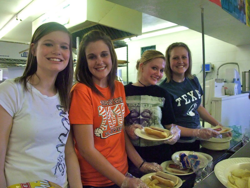 Image: Morgan, Ella, Emma and Mikalla   — Morgan Scruggs, Ella Presley, Emma Presley and Mikalla Wimbish (all freshmen students) were serving up hotdogs with a smile.