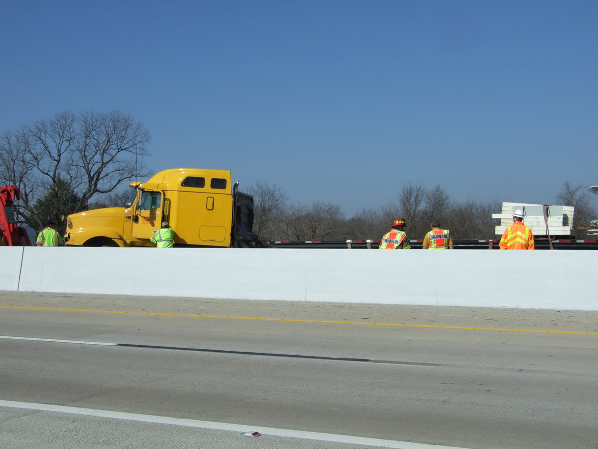 Image: Jackknifed Semi — Trying to avoid a car, the driver of this truck swerved and hit the concrete barrier.