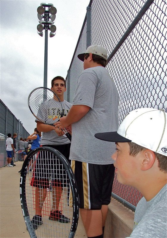 Image: Talking tennis — Cody Medrano, Kevin Roldan and Zain Byers pass the time between matches.