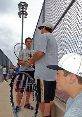 Image: Talking tennis — Cody Medrano, Kevin Roldan and Zain Byers pass the time between matches.