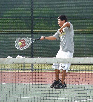 Image: Just his racket — Into the swing of things, Cruz Enriquez keeps his challengers busy.