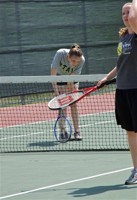 Image: Courage — Melissa Smithey uses her tennis racket for support after taking ill during a match. After a quick break, Smithey recovered enough to secure 3rd place in district with her doubles partner, Drenda Burk.