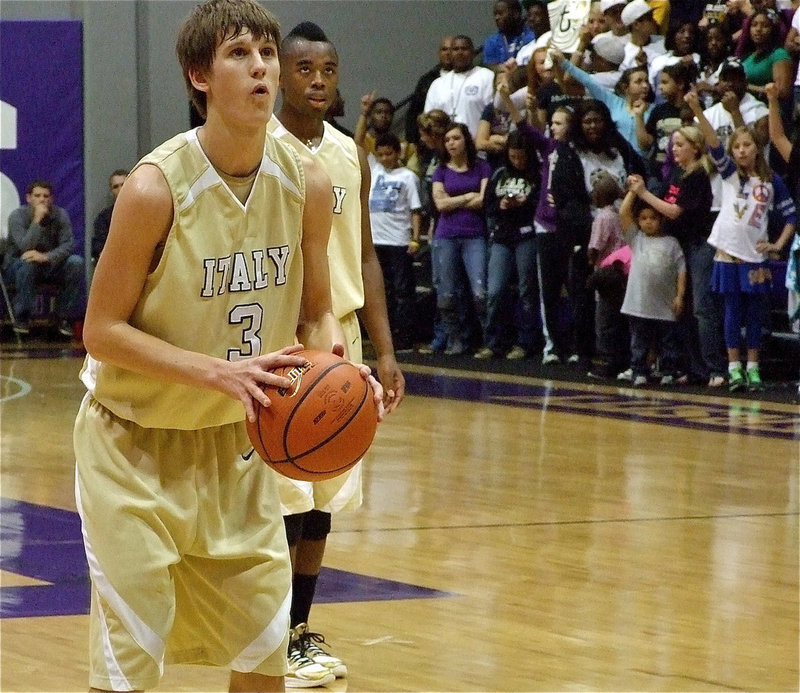 Image: Crowd support — Jasenio Anderson(11) looks on as teammate Jase Holden(3) shoots a free-throw.