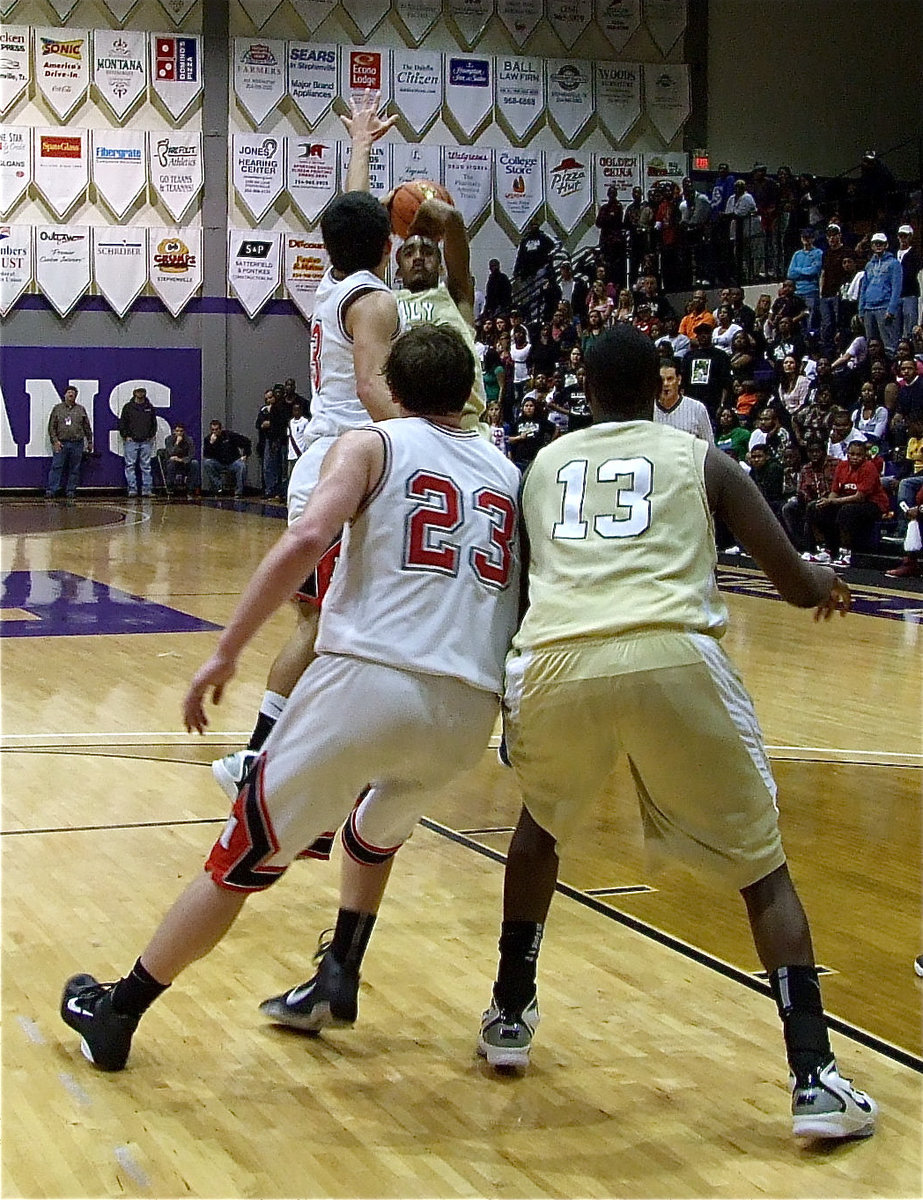 Image: Clemons takes a shot — Senior Heath Clemons(2) rises for a jumper while Larry Mayberry(13) battles on the block with Melissa’s Hondo Webb(23).