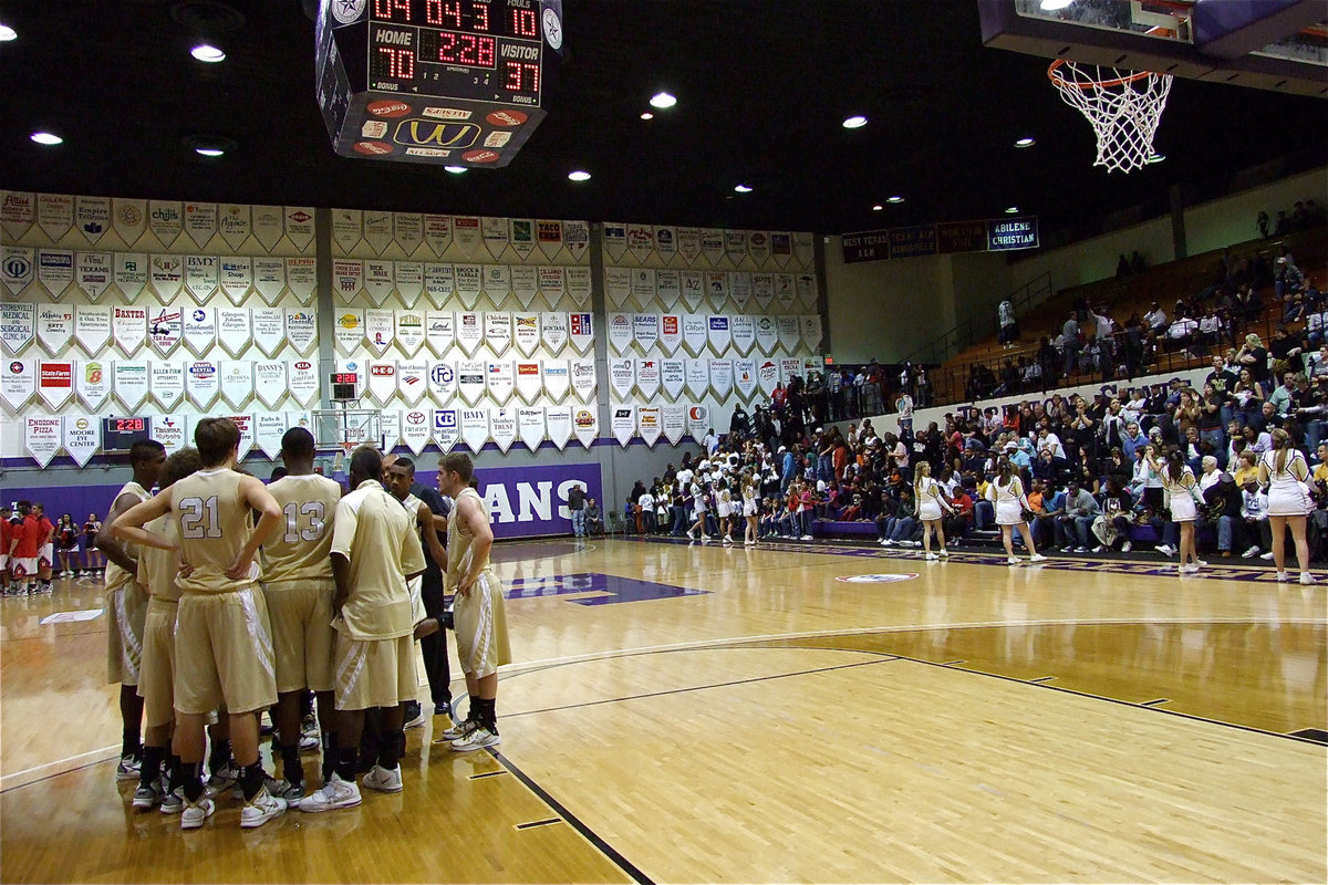 Image: Finish strong! — The Gladiators huddle away from the Cardinal’s crowd late in the fourth with the season slipping away.