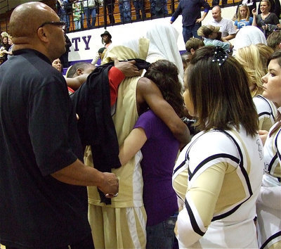 Image: Leaving as a legend — Senior Heath Clemons(2) receives hugs form fans as he exits the basketball court in a Gladiator uniform for the last time.