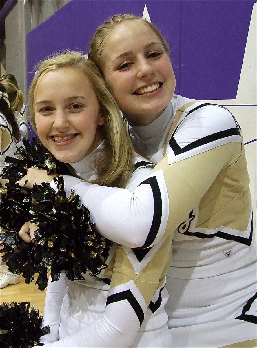 Image: Hugs! — Gladiator cheerleaders Kelsey Nelson and Madison Washington begin the celebration late in the fourth quarter.