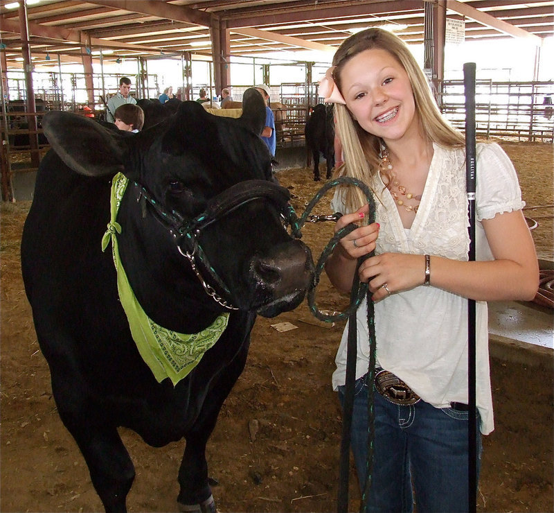 Image: The Champs! — Bailey Eubank and her Grand Champion steer, Raider, get ready to enter the Expo sale ring on Saturday.