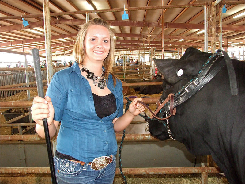 Image: Jacqualyn Crowley — Jacqualyn Crowley takes a moment before entering the chutes with her steer that was able to bump up and make the sale.