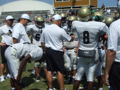 Image: Bales talks — Head football Coach Craig Bales instructs his players before the scrimmage against Blooming Grove.