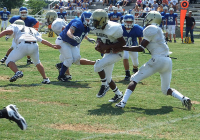 Image: Clemons carries — Heath Clemons takes the ball from Jasenio Anderson.