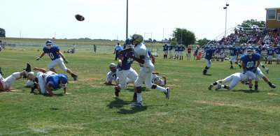 Image: Air mail — Italy quarterback Jasenio Anderson puts his stamp on the game as he releases the pass just in time.