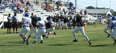 Image: Lions give Chase — Running back Chase Hamilton #24 rumbles through the Lion defense.