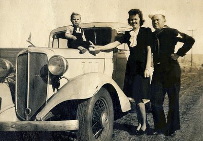 Image: Family photo — The Bryants pose for a photo beside the family’s Ford with son William Jefferson sitting on the car’s hood.
