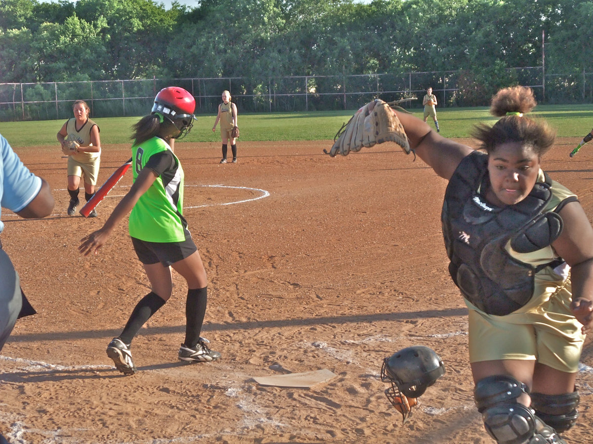 Image: Sa’Kendra Norwood gives a Lady Gladiator effort behind the plate — Sa’Kendra Norwood gives 110% against Hillsboro in the Girls 15 &amp; under division.