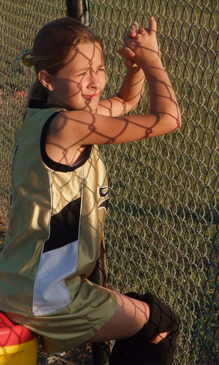 Image: Can’t wait to play — This yonger softball player is watching the older girls compete against Hillsboro while she patiently waits for her day in the sun.