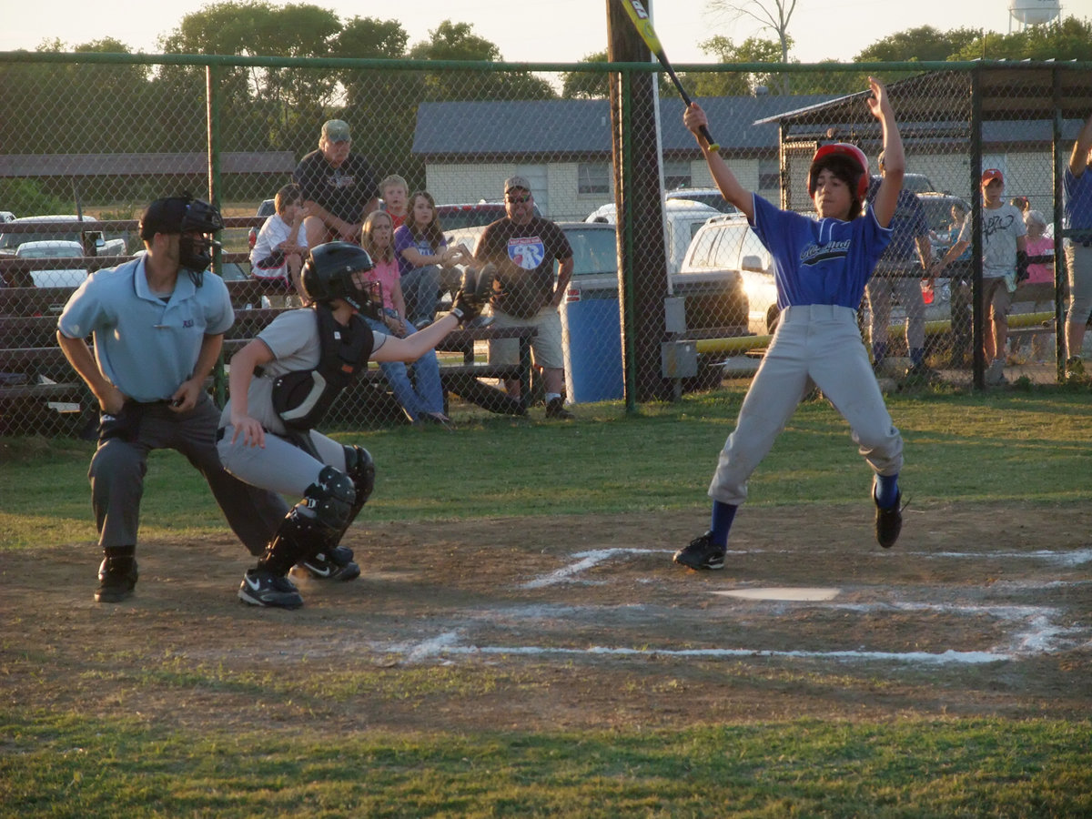 Image: Just a bit outside — Jacob Gonzalez controls what was really more of an inside pitch from Justin Wood.