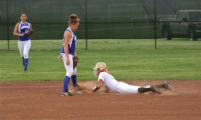 Image: Total effort — Megan Richards slides safely into second base despite her sore ribs.