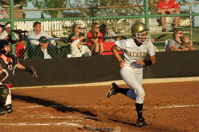 Image: Making things happen — Anna Viers hits then sprints to first base against Axtell.