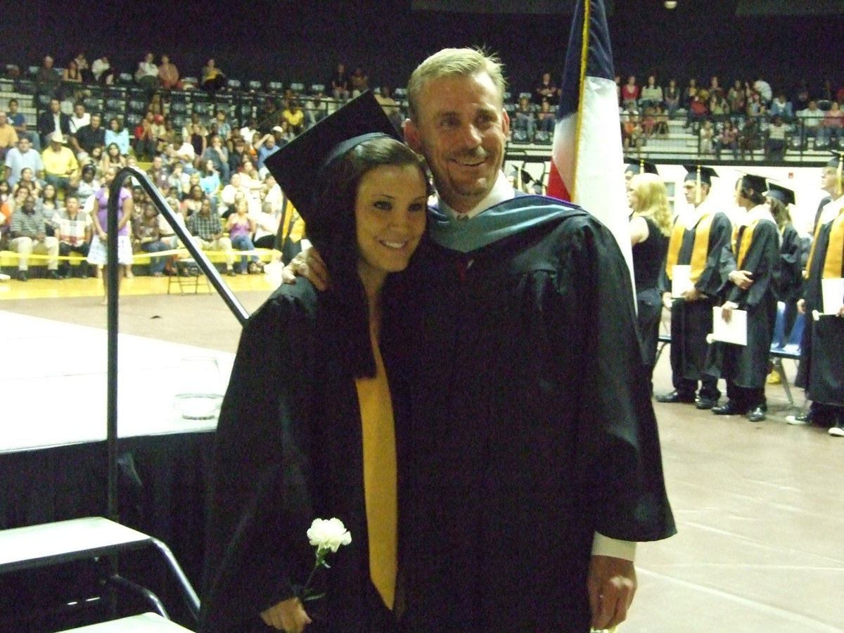 Image: Annalee Graduates — Annalee Lyons receives her diploma, carnation and a last hug from Mr. Herald at the graduation ceremonies Friday night at Italy High School.