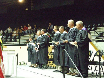 Image: Esteemed members assemble — School board, administration, faculty and guests assemble on the stage for graduation.