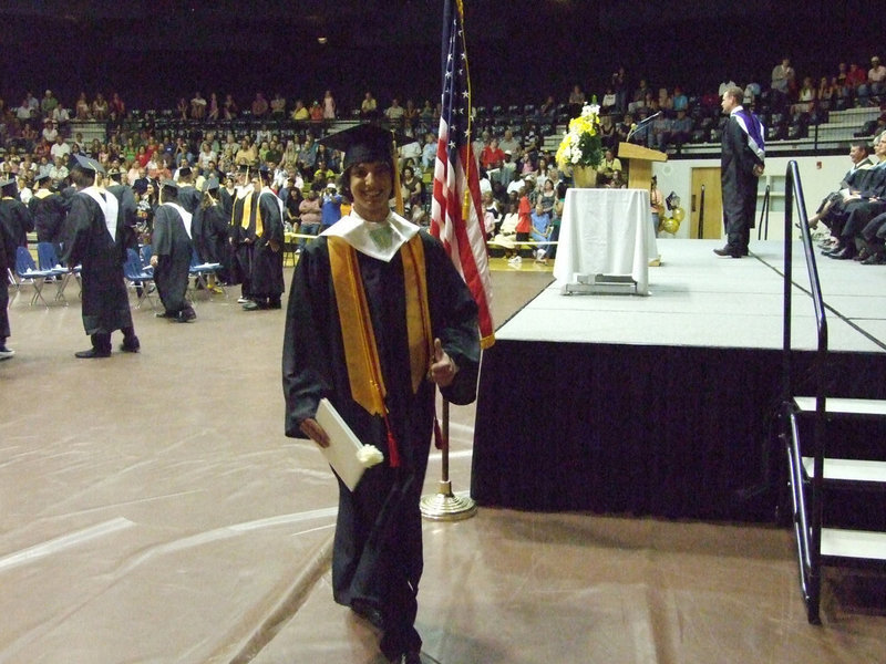 Image: Chase makes his way to the stage — Chase Michael is invited to the stadium to lead his class in the singing of the school song.