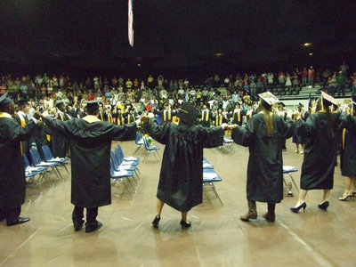 Image: Hands held tight — The graduates circle up and sing the school song as alumni.