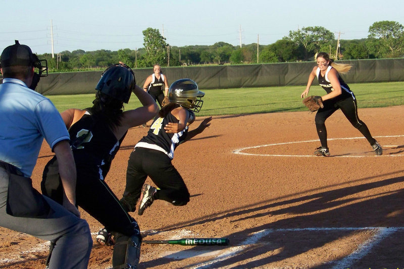 Image: Mariesella Perez — Perez puts down a bunt and hussles down the line.  Perez was injured during this play in a collision with a Meridian defensive player at 1st base and had to be carried off the field.