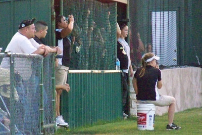 Image: Making adjustments — Coach Tina Richards signals her outfielders to adjust their location on the field.