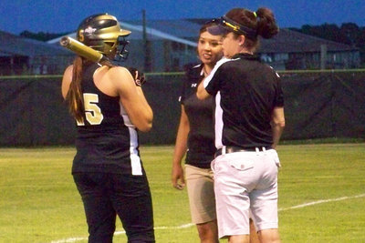 Image: Quick Conference — Before her at-bat, the Meridian defense called a timeout where Coaches Richards and Windham give Jeffords a quick pep-talk (which obviously worked since she hit an over the fence homerun during this at-bat).