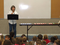 Image: Carolyn Maevers — Miss Maevers (principal) addressing the students.