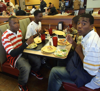Image: Take It To The Hole — (Left to right) DeAndre Sephus, Aaron Thomas, Heath Clemons and Darrin Moore can’t miss when eating pizza.