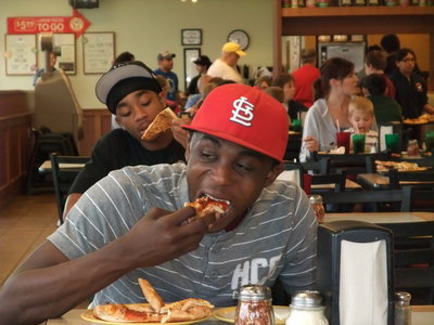 Image: Slamming — Diamond Rodgers and Dontavius Clemons (In back) apply their basketball skills at CiCi’s and slam down several pizza slices.
