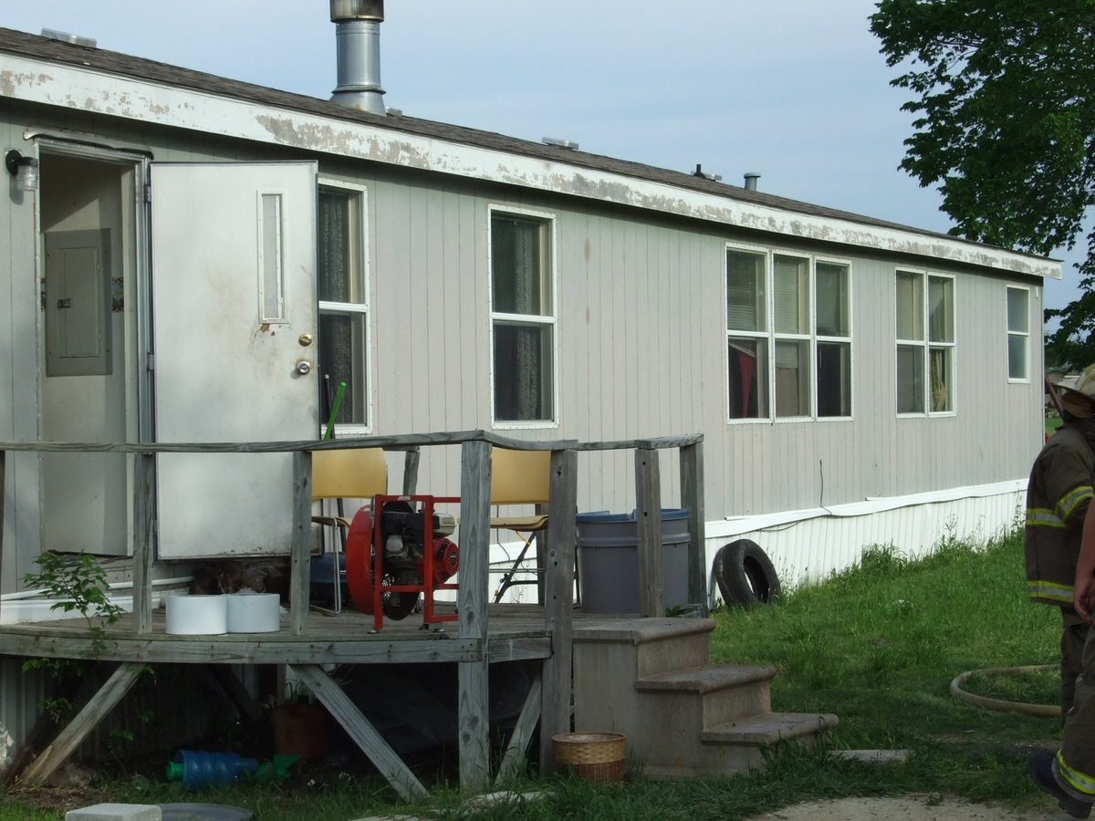 Image: This Is The House — This double wide trailer has lots of smoke damage.