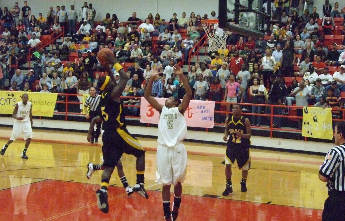 Image: Defending the “Gold” — Itasca’s #5 Mikey Marshall tries to shoot over the ultimate defender, Dontavius (Maximus) Clemons #5.